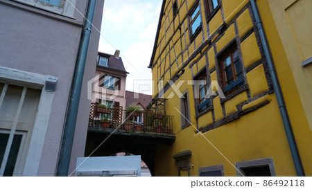 Colmar, Petit Venice, narrow street and traditional half timbered colorful houses at winter with christmas decorations . Alsace, France. Colmar, Petit Venice, narrow street and traditional half timbered colorful houses at winter with christmas decorations . Alsace, France. 86492118