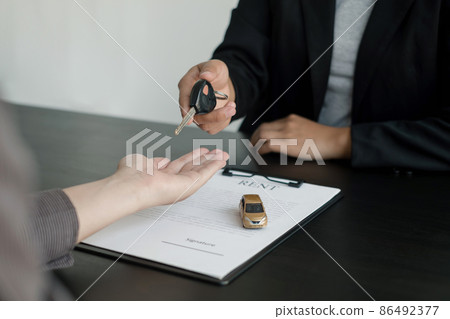 The car dealer provides advice on loans, insurance details, and car rental information, and delivers the car with the keys after the rental contract is signed 86492377