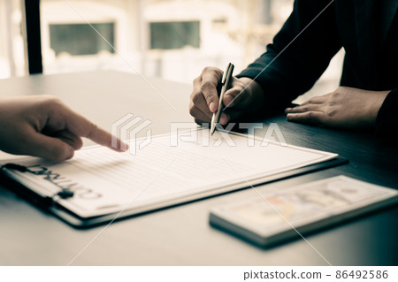 Corruption. Businessmen make an agreement with the money proposed his partner to bribe in the office and make a contract under an agreement. Illegal money fraud The concept of bribery and corruption Corruption. Businessmen make an agreement with the money proposed his partner to bribe in the office and make a contract under an agreement. Illegal money fraud The concept of bribery and corruption 86492586