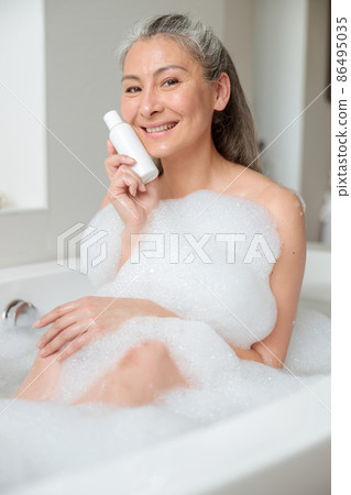 Female holding natural skincare or body care cosmetic Female holding natural skincare or body care cosmetic 86495035