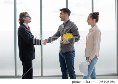 Shake hand Team of male and female engineers and architects, working team, meeting, discussing construction and drawing construction plans, printing, writing on-site construction sites 86496160