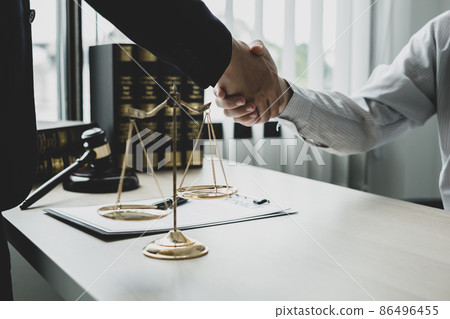 shake hand Professional male lawyers work at a law office There are scales, Scales of justice, judges gavel, and litigation documents. Concepts of law and justice 86496455
