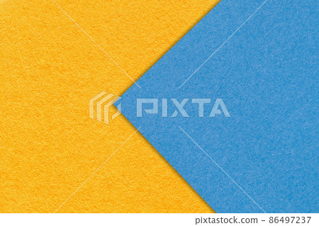 Texture of orange and blue paper background, half two colors, macro. Yellow and sky trendy palette. Texture of orange and blue paper background, half two colors, macro. Yellow and sky trendy palette. 86497237
