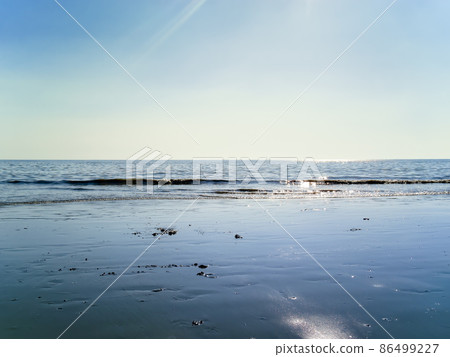 Calm blue sea and sky Calm blue sea and sky 86499227