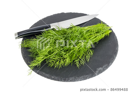 Bunch of fresh green dill on black stone. 86499488