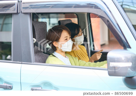 Female driving a passenger car Female driving a passenger car 86500699
