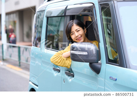 Female driving a passenger car Female driving a passenger car 86500731