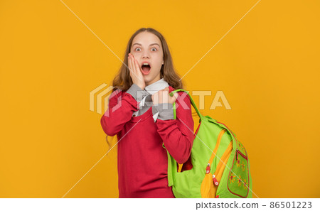 amazed kid with school backpack on yellow background, school amazed kid with school backpack on yellow background, school 86501223