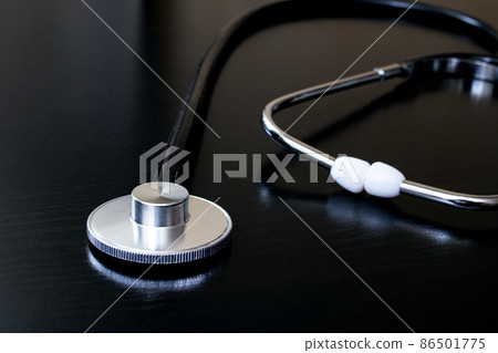 Medical stethoscope on a black table closeup 86501775