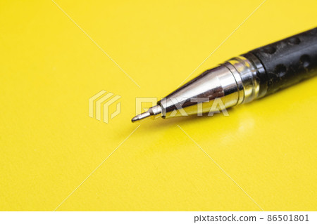 Black pen on a yellow background closeup Black pen on a yellow background closeup 86501801