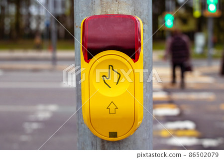 Traffic light button at a pedestrian crossing Traffic light button at a pedestrian crossing 86502079