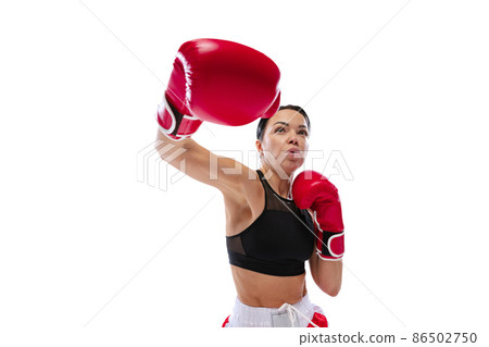 Front camera view of young girl, professional boxer practicing in sports uniform and boxing gloves isolated on white studio background. Concept of sport, studying, competition Front camera view of young girl, professional boxer practicing in sports uniform and boxing gloves isolated on white studio background. Concept of sport, studying, competition 86502750