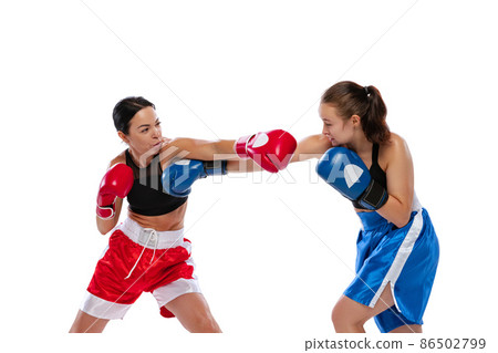 Two woman professional boxers boxing isolated on white studio background. Couple of fit muscular caucasian athletes fighting. Sport, competition Two woman professional boxers boxing isolated on white studio background. Couple of fit muscular caucasian athletes fighting. Sport, competition 86502799