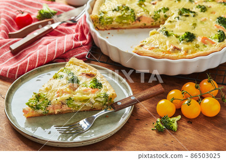 Homemade quiche with red fish, salmon, broccoli and cheese on wooden background Homemade quiche with red fish, salmon, broccoli and cheese on wooden background 86503025