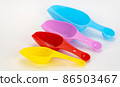 spatulas for cereals and spices on a white background. set of colored scoops for bulk products 86503467