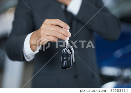Close up of male customer holding keys from new auto 86503514