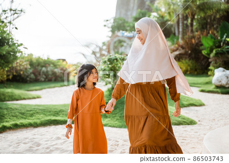 muslim mother and daughter walking and hold hand together 86503743