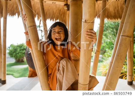 happy kid happy climbing on bamboo pole 86503749