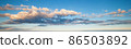 Blue sky with clouds in sunset light panorama 86503892