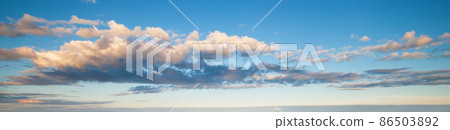 Blue sky with clouds in sunset light panorama 86503892