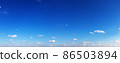 Clear blue sky with small clouds in summer day 86503894