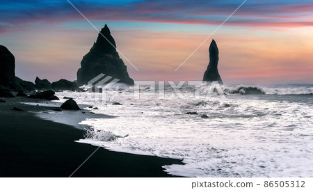 Vik and Basalt Columns at sunset, Black Sand Beach in Iceland. 86505312