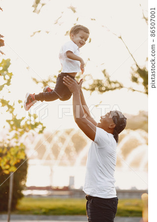 Father and son having fun in summer park 86507001