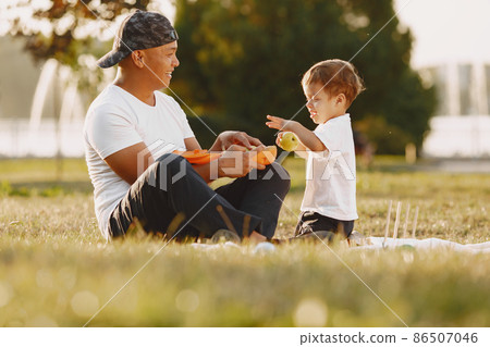Father and son having fun in summer park Father and son having fun in summer park 86507046