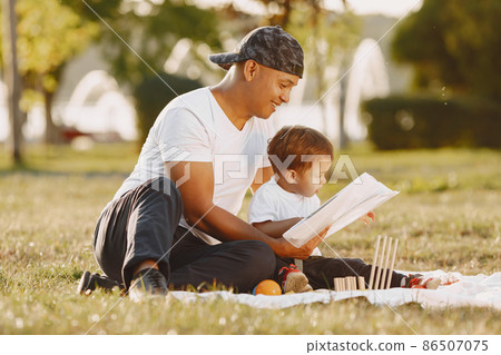 Father and son having fun in summer park 86507075