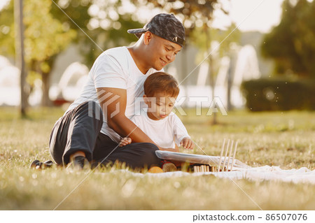 Father and son having fun in summer park 86507076