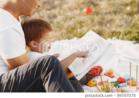 Father and son having fun in summer park 86507078