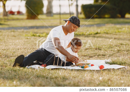 Father and son having fun in summer park Father and son having fun in summer park 86507086
