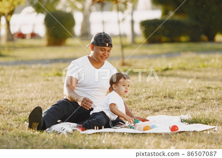 Father and son having fun in summer park 86507087
