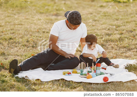Father and son having fun in summer park Father and son having fun in summer park 86507088