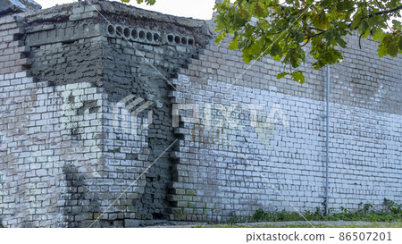 collapsing corner of a brick building after an earthquake 86507201
