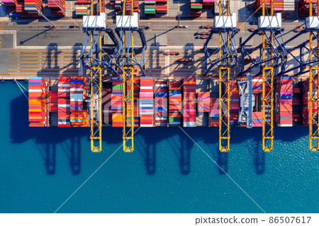 Aerial view of cargo ship and cargo container in harbor. Aerial view of cargo ship and cargo container in harbor. 86507617