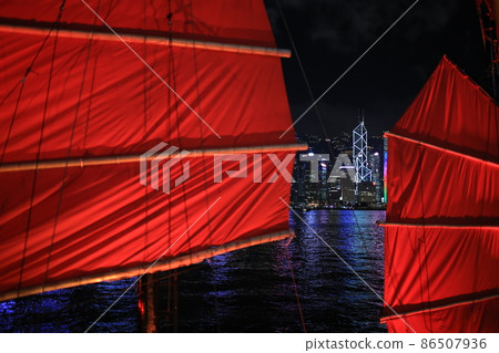 Chinese red junk with the victoria harbor night view background in hong kong Chinese red junk with the victoria harbor night view background in hong kong 86507936