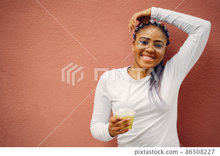 Portrait beautiful smiling african woman in city closeup Portrait beautiful smiling african woman in city closeup 86508227