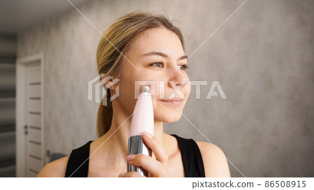 Beautiful woman is using vacuum device for removing blackheads Beautiful woman is using vacuum device for removing blackheads 86508915