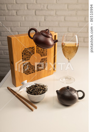 tea table with appliances and wine glasses, in which large-leaf tea is brewed 86510994