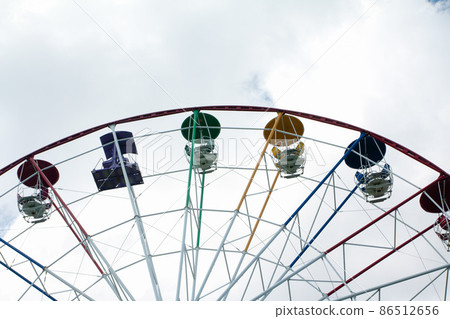 Ferris wheel in an amusement park Ferris wheel in an amusement park 86512656