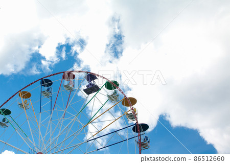 Ferris wheel in an amusement park Ferris wheel in an amusement park 86512660