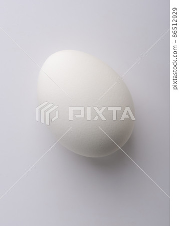 Light and shadow on a chicken egg. Light on the sharp end of the egg. 86512929