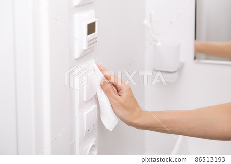 Cleaning switches and sockets with a microfiber cloth. Sanitize surfaces prevention in hospital and public spaces against corona virus. Woman hand using wet wipe for cleaning home room door link. Cleaning switches and sockets with a microfiber cloth. Sanitize surfaces prevention in hospital and public spaces against corona virus. Woman hand using wet wipe for cleaning home room door link. 86513193