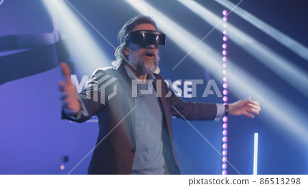 Man in virtual reality gadget at Metaverse conference 86513298