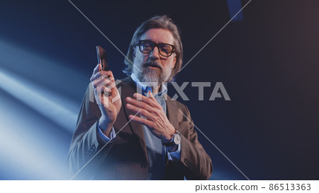 Man showing the new design of the smartphone Man showing the new design of the smartphone 86513363