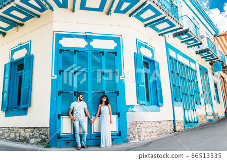 A couple in love walks the beautiful streets. Man and woman traveling. The couple travels to Cyprus. Man and woman near the cafe. Couple holding hands. Honeymoon trip. Newly married couple A couple in love walks the beautiful streets. Man and woman traveling. The couple travels to Cyprus. Man and woman near the cafe. Couple holding hands. Honeymoon trip. Newly married couple 86513535