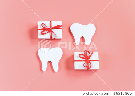 Happy dentist day. Paper cut mockup of tooth and gift boxes on pink background. Dental care concept. Greeting card. Copy space. Happy dentist day. Paper cut mockup of tooth and gift boxes on pink background. Dental care concept. Greeting card. Copy space. 86513860