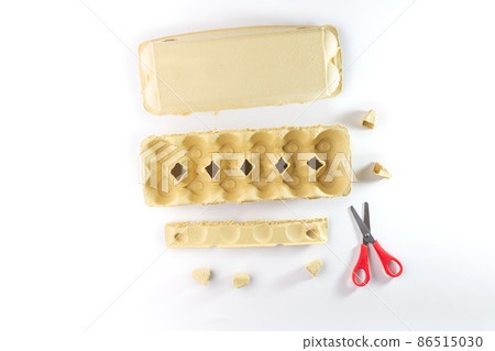 empty yellow egg container for Easter paper craft, DIY instructions, recycling concept 86515030