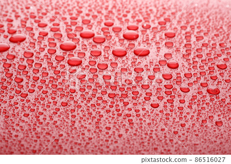 Water drops on red background, closeup view 86516027